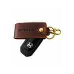 Brown leather keychain with decorative metal charm by ESS9.pk